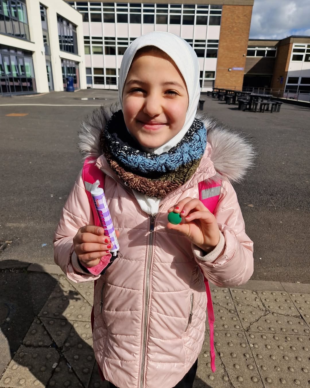 Maryam holding the Green badge