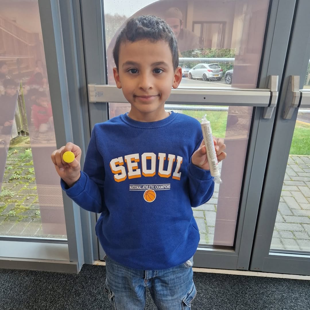 Rayan holding his yellow badge